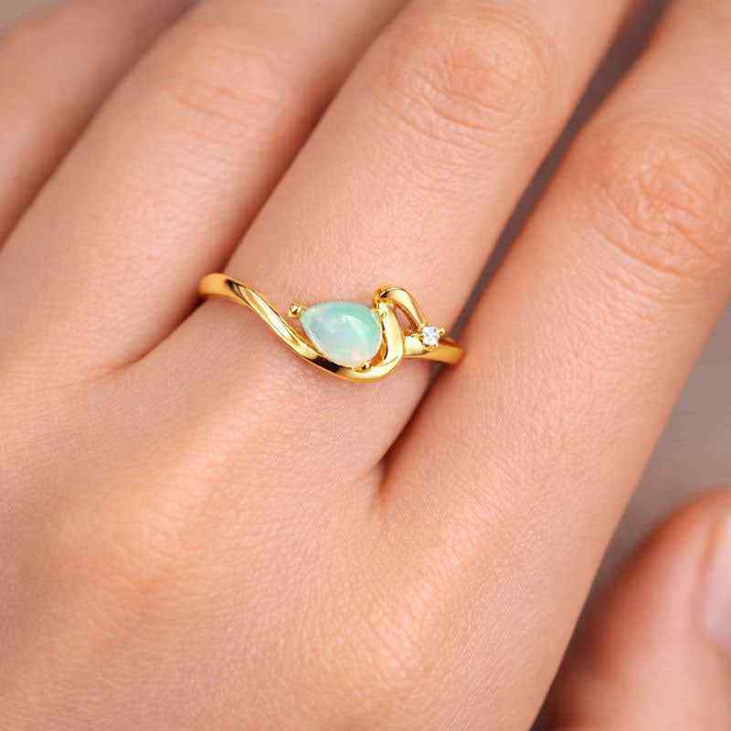White Ethiopian Opal teardrop ring with 4x6mm gemstone in sterling silver band, handcrafted jewelry for women.