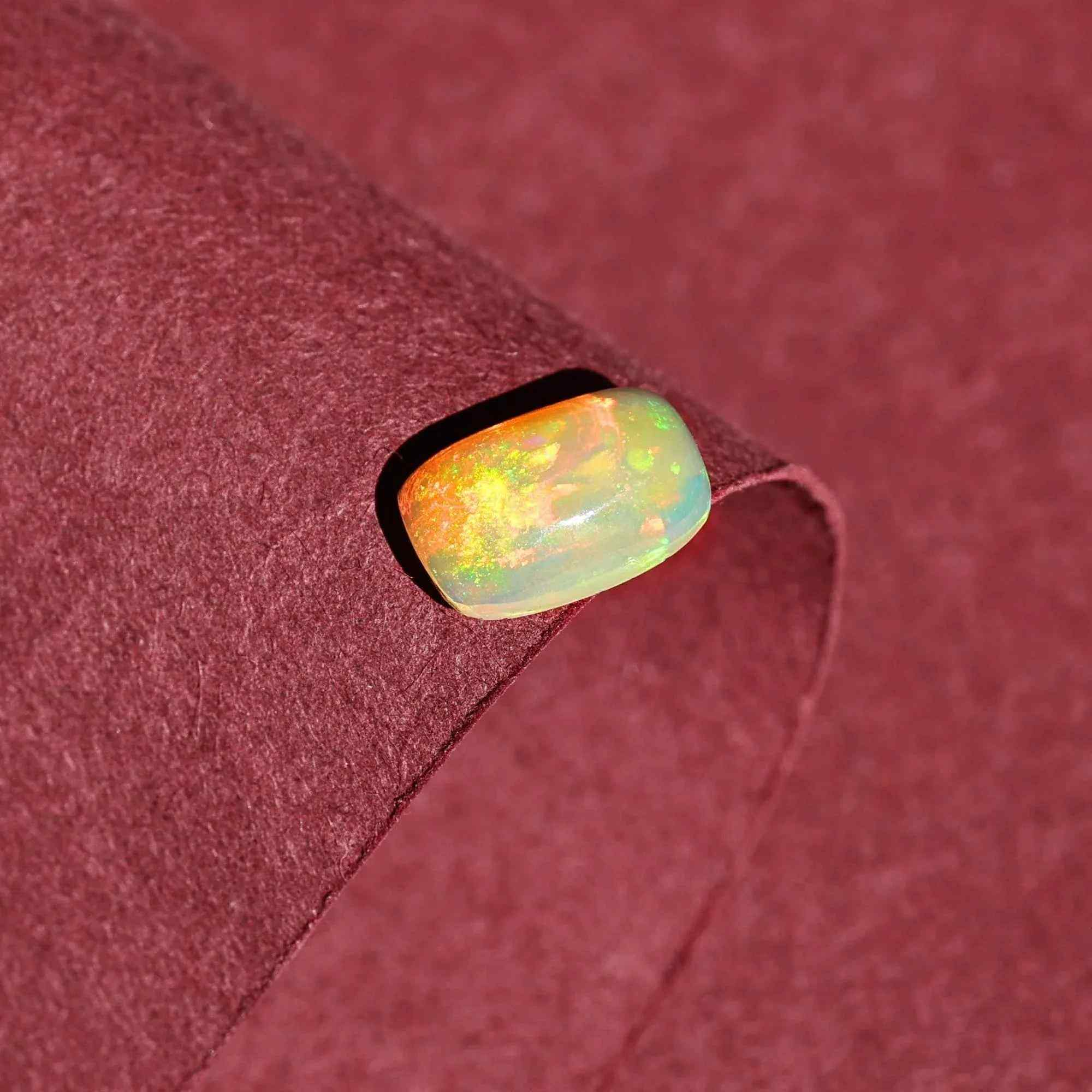 Yellow fire opal gemstone cabochon with vibrant yellow color, part of Himalya Quartz's loose gemstone collection.