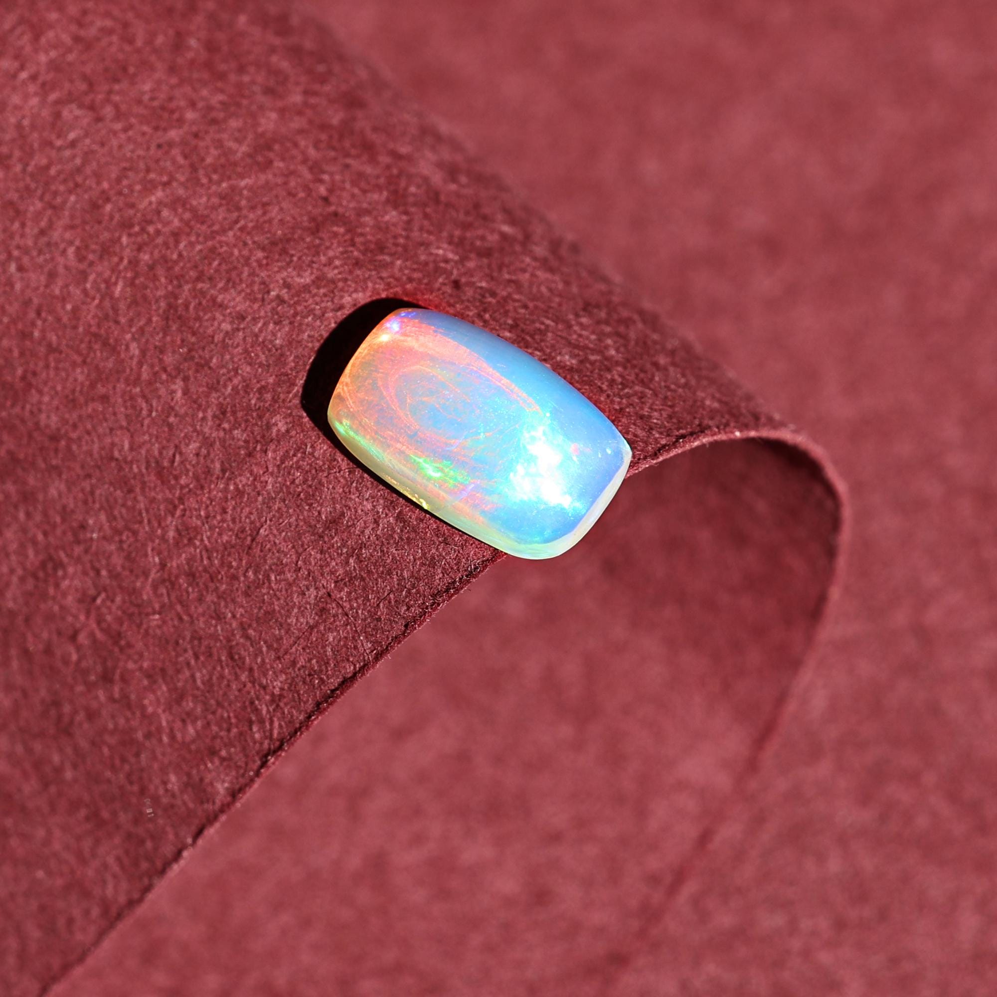 1.58 Carat Ethiopian Opal Gemstone: Rainbow Fire, Long Cushion Cabochon
