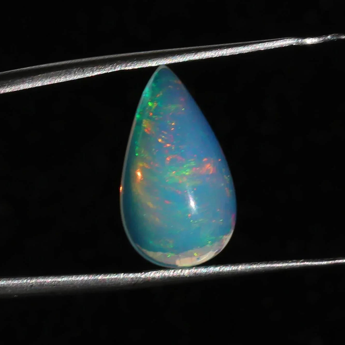 Ethiopian Welo Opal Cabochon: Rainbow Fire Pear-Cut Gemstone, 4.77 CT loose gemstones