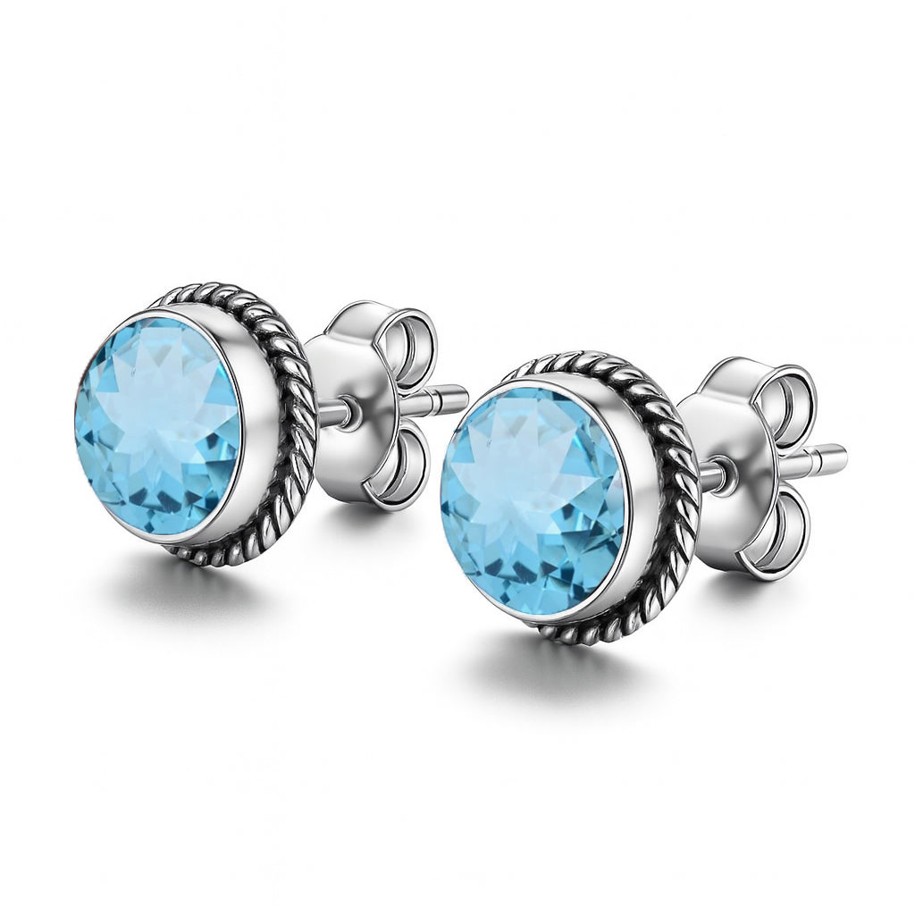 Blue Topaz 6mm round cut sterling silver stud earrings by Himalya Quartz, showcasing sparkling gemstone gemstones in a classic stud design.
