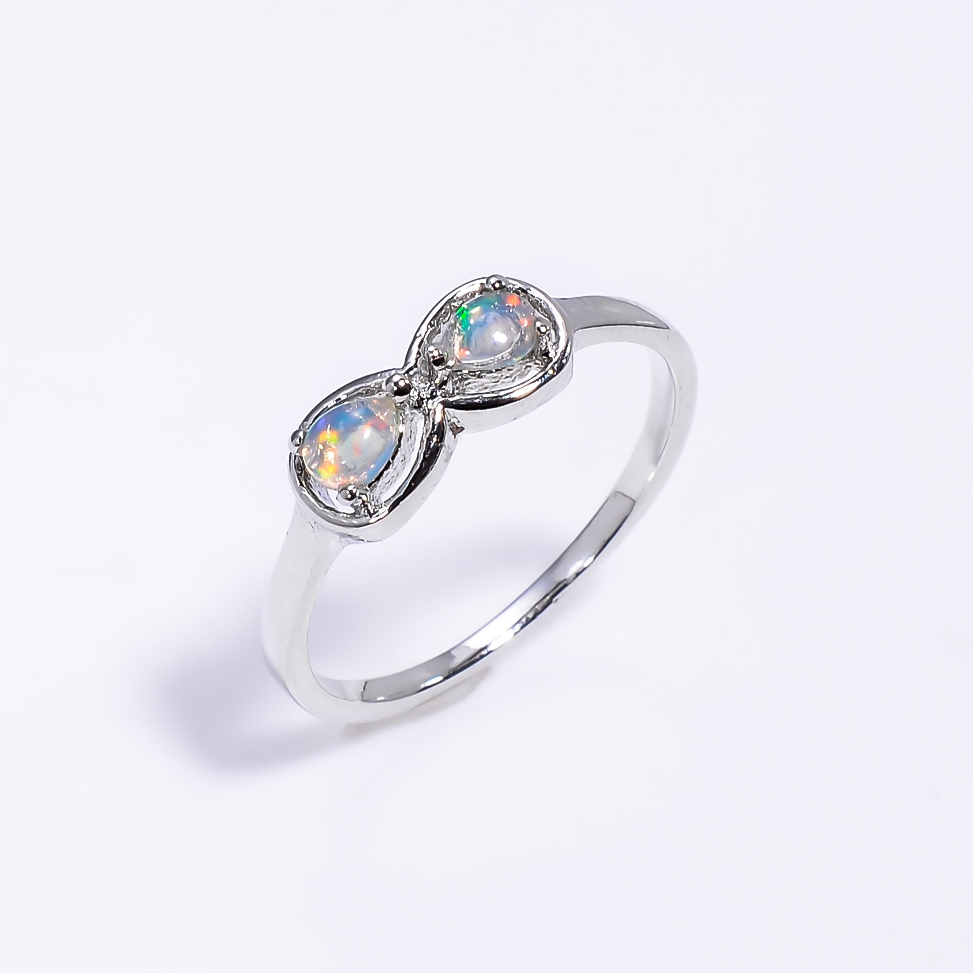 Sterling silver Ethiopian opal pear ring with 3x4mm opal for women, featuring a delicate design and vibrant gemstone.