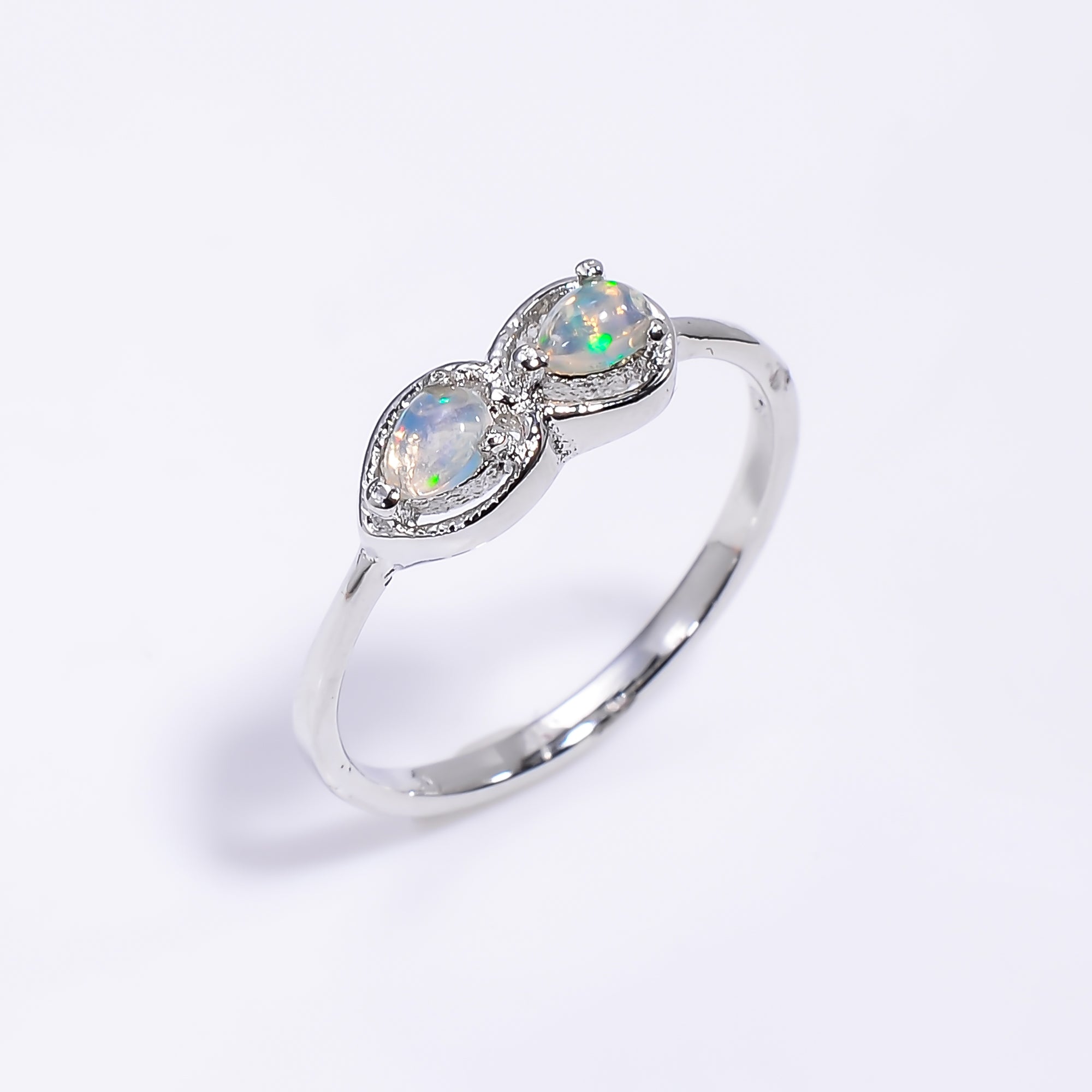 Pear cut Ethiopian opal ring in 925 sterling silver featuring a 3x4mm opal, handcrafted jewelry ring for women.