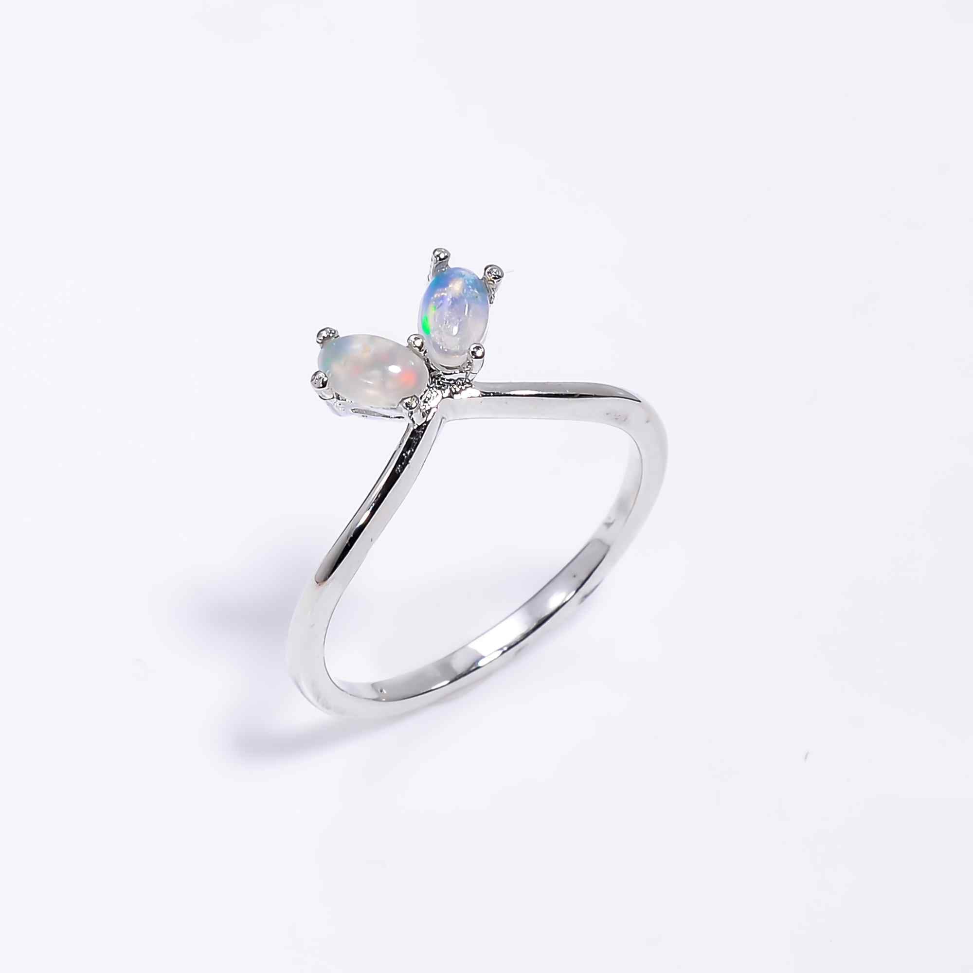 Natural Ethiopian opal stud earrings with 3x5mm oval cabochons set in sterling silver, showcasing vibrant play of colors.