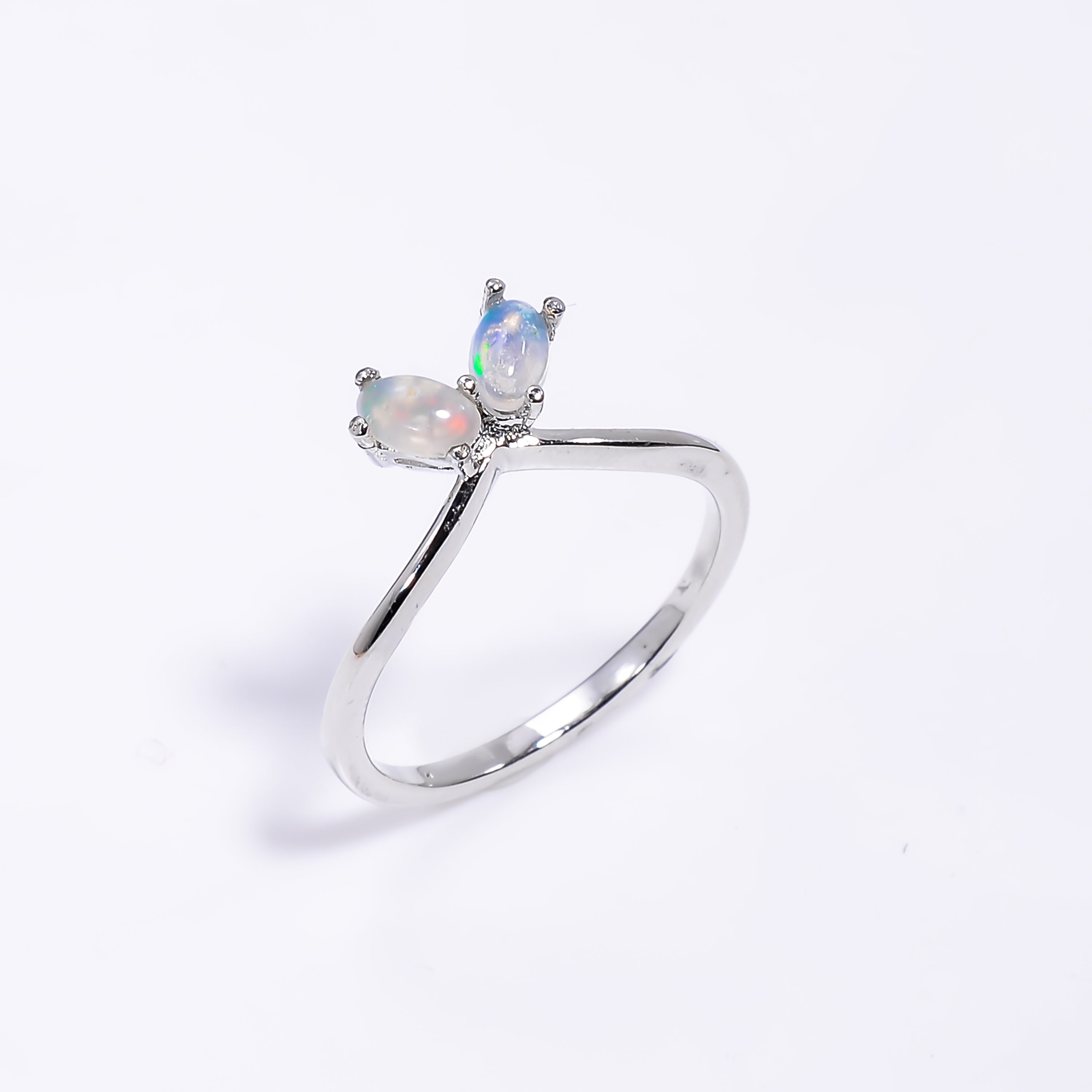 Natural Ethiopian opal stud earrings with 3x5mm oval cabochons set in sterling silver, showcasing vibrant play of colors.