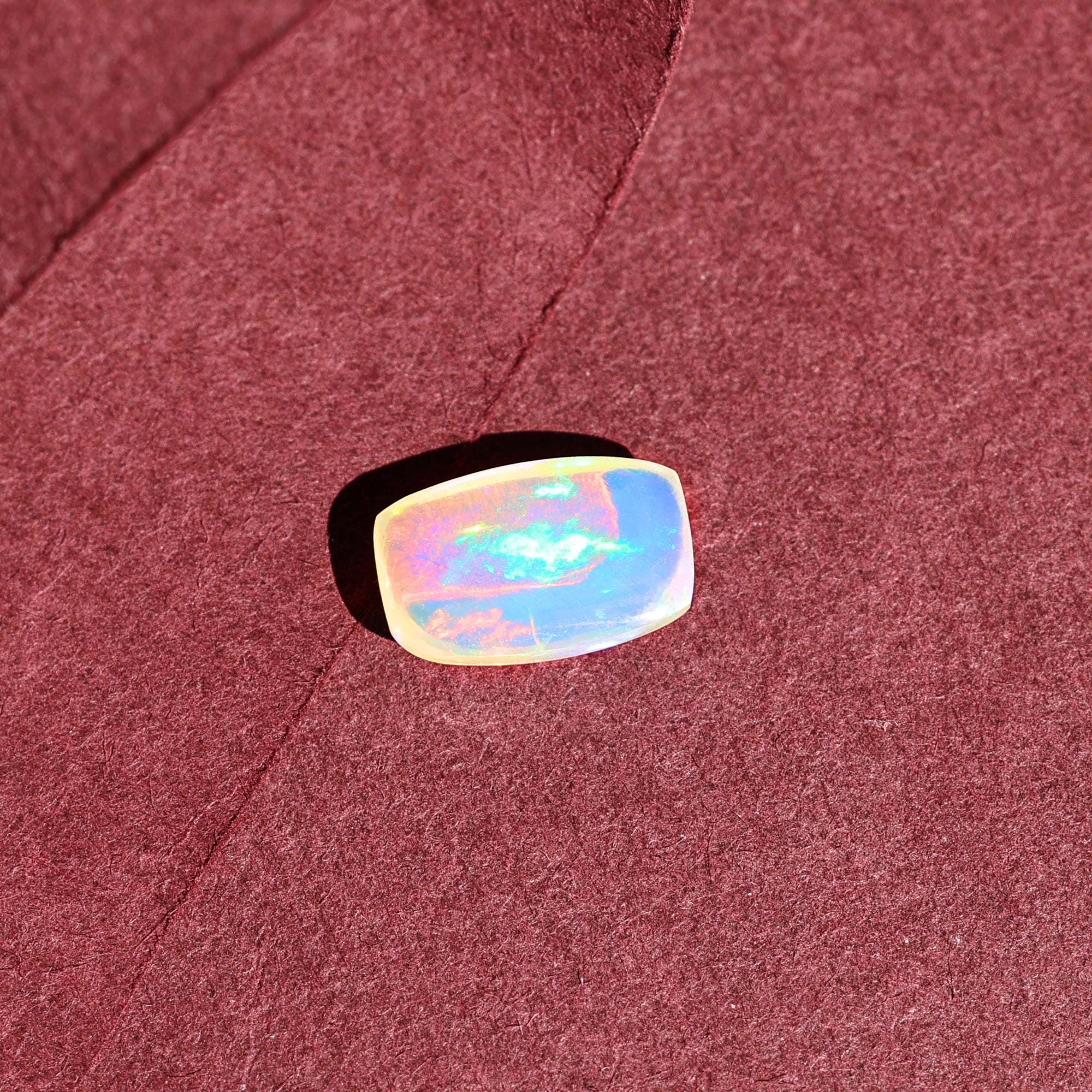 1.58 Carat Ethiopian Opal Gemstone: Rainbow Fire, Long Cushion Cabochon